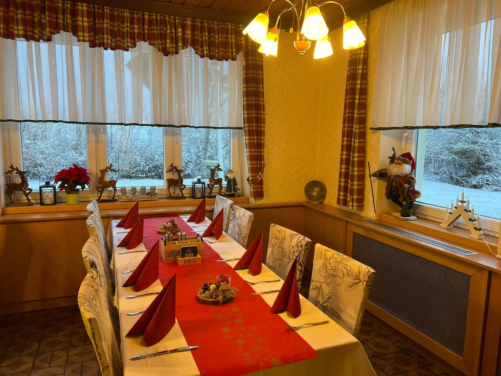 Festively laid table in the cosy dining room at Gasthof Hochsteiner